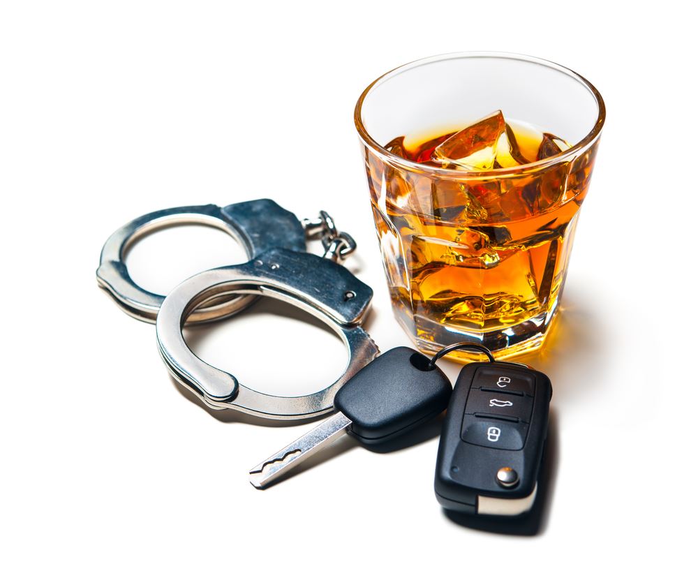Handcuffs, car keys, and a glass of alcohol